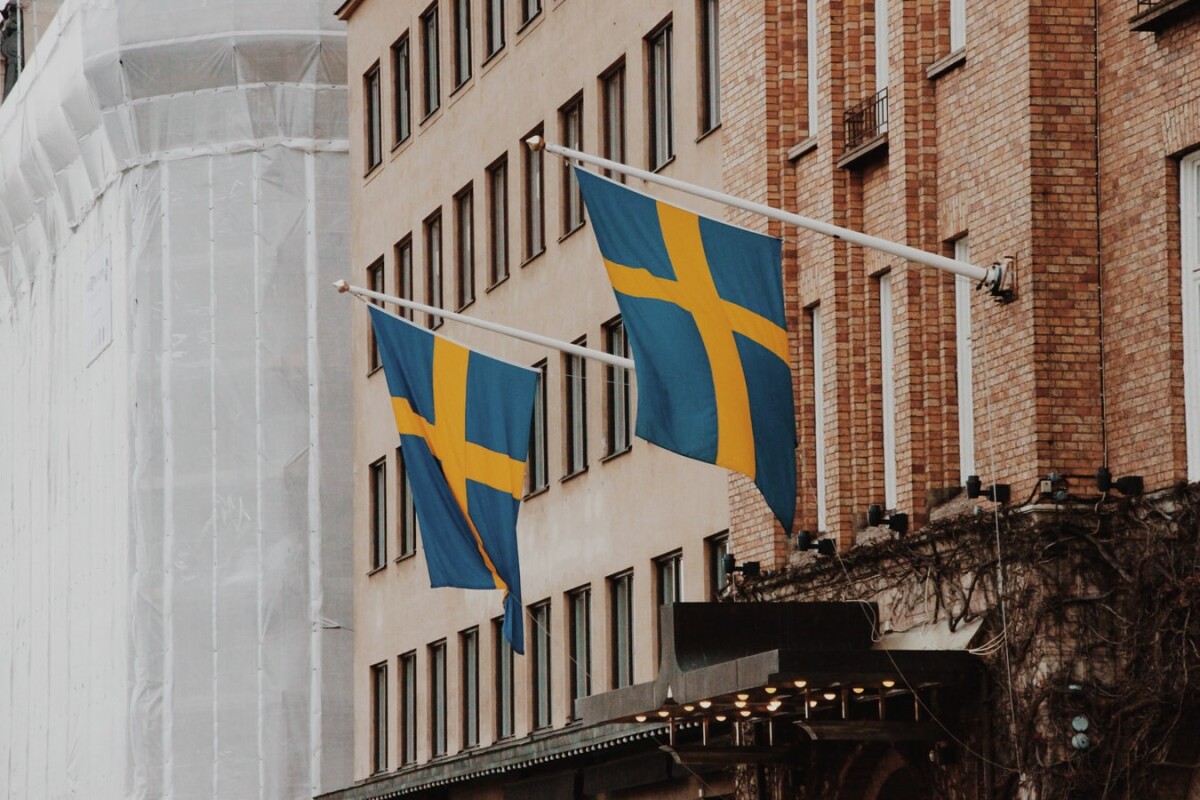 A couple of Sweden flags - Sweden Implements Tougher Labour Immigration Policies.